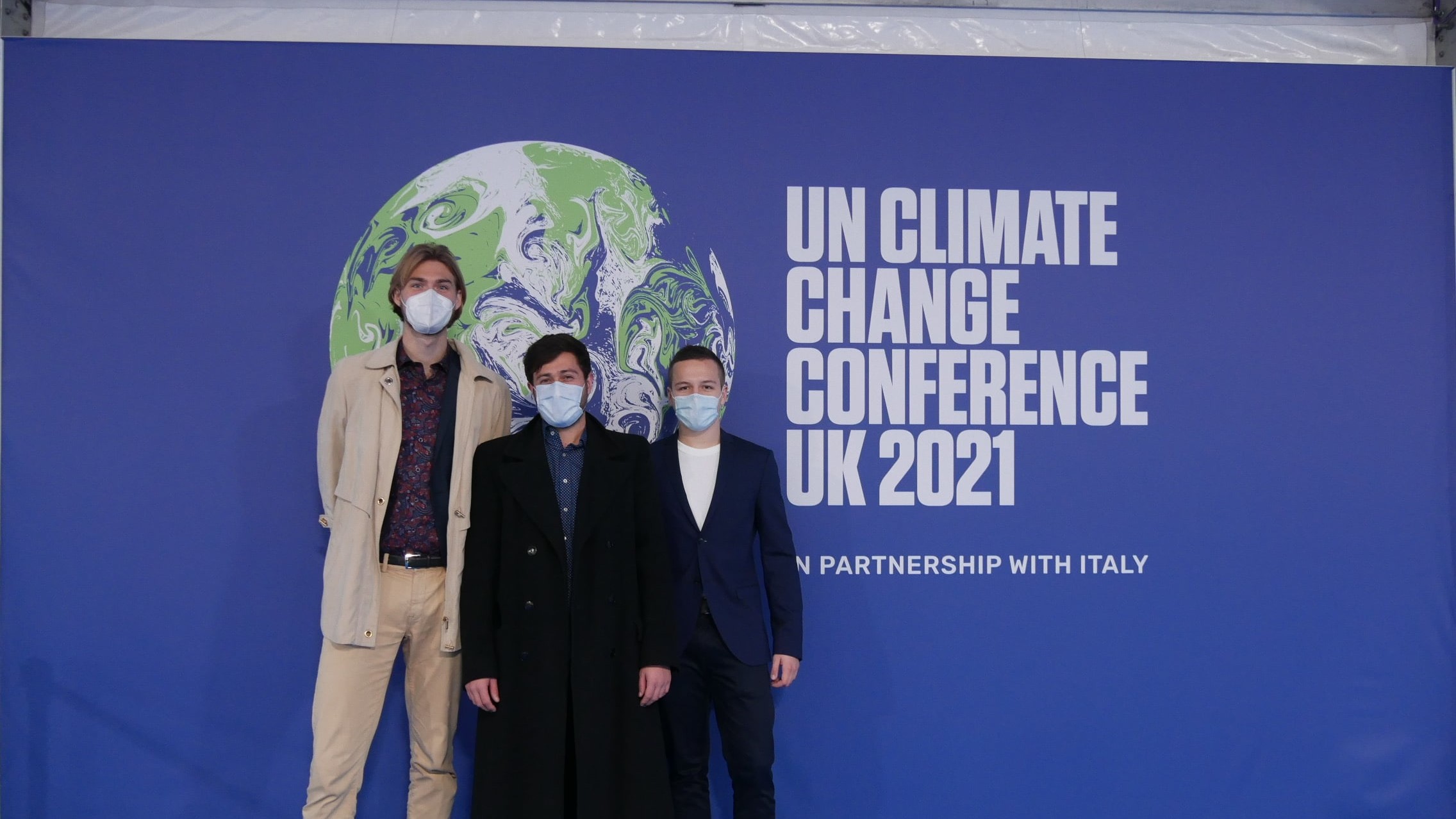 Nico, David and Leo in front of COP26 banner