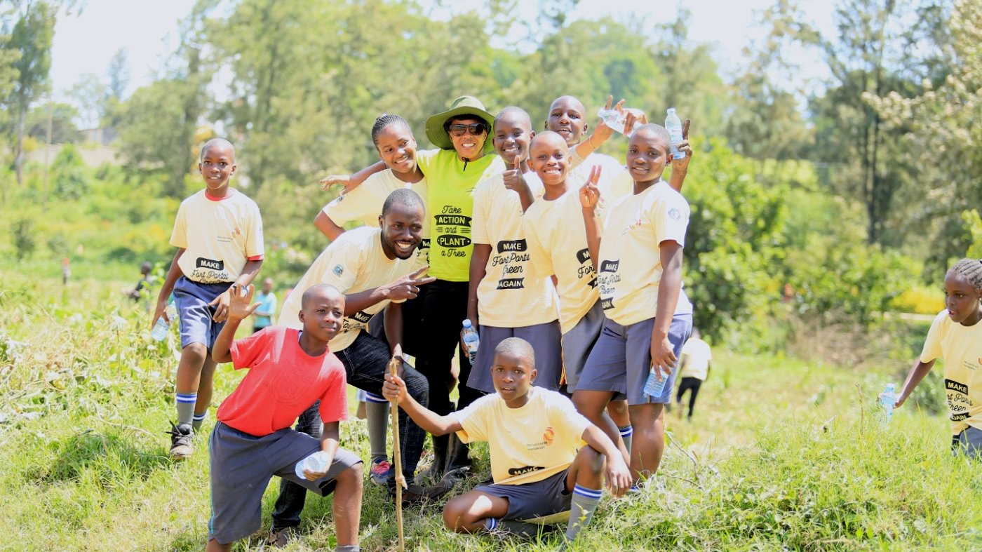 Patience Namara Takes a Group Photo with Students At the Urban Greening Campaign in Fort Portal City